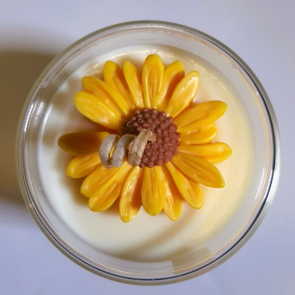 Closeup of top of Floating flower candle with sunflower on top